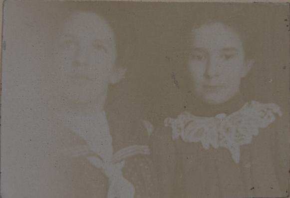 Badly faded and faint photograph of two women