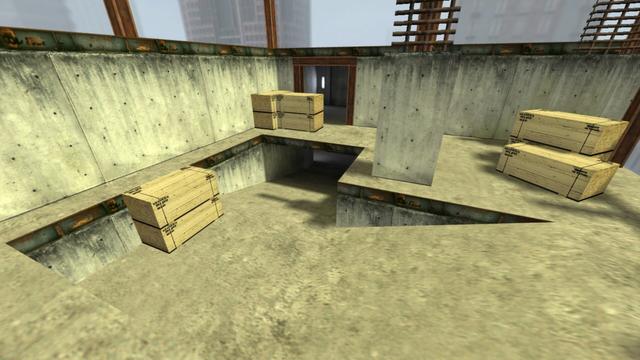 In this picture you can see the exterior and also the top part of the skyscraper. The top part is connected to a concrete ramp on the lower floor. You can see wooden boxes scattered again, as well as you notice the shell again, because you can only see concrete walls, steel beam, etc. In the background you can see the sky, as well as other skyscrapers. This is on the map de_vertigo in the game Counter-Strike 1.6.