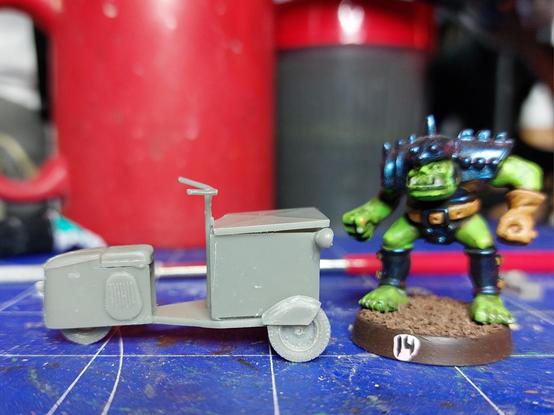 Small 1940s airport cargo scooter with a box on front. It's all very fragile. The 1988 blood bowl orc for scale isn't. The plan is to let a pistol wielding grot show up from the cargo box with the lid being raised