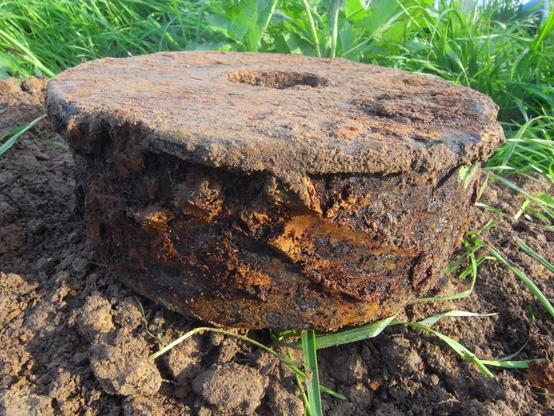 This anti-tank mine from World War II IS rough and has a rough and rusty surface. It had just been dug out of a meadow where it had been tracked down with a metal detector.