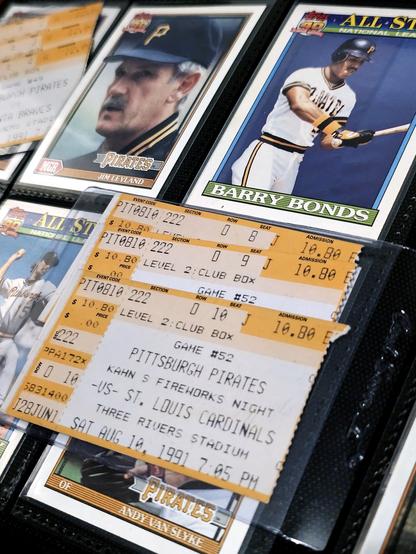 A closeup of 1991's Topps Baseball cards - Pittsburgh Pirates - Manager Jim Leyland, Barry Bonds and Andy Van Slyke (who's card is obscured by 1991 Tickets for a Pirates baseball game).