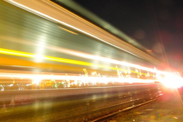 Multi colored light streams from a passing train.