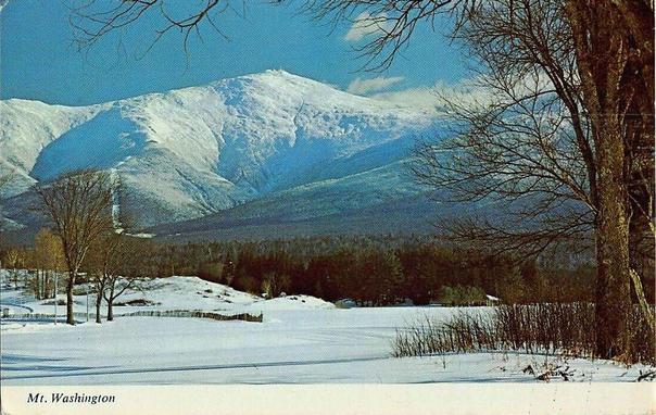 In the background is the mountain. You see the faint outline of the weather station. There is snow on the mountain, and the landscapes in the foreground.