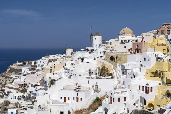 Iconic View Windmills and Whitewashed Buildings in Oia Santorini Greece II

The view of the iconic windmills and whitewashed buildings in Oia, Santorini, Greece, is nothing short of breathtaking. Perched on the northern tip of the island, Oia offers a stunning panorama of traditional Cycladic architecture.

The buildings, with their smooth, white facades, are often adorned with blue-domed roofs that reflect the deep azure of the Aegean Sea below. The narrow, cobblestone streets wind gracefully through the village, dotted with colorful bougainvillea flowers spilling over walls and balconies. The windmills, with their classic white structures and wooden sails, are set against the golden hues of the setting sun, creating a romantic and timeless scene.

Below the cliffs, the caldera spreads out in a vast expanse of shimmering blue water, and nearby islands are visible in the distance. The interplay of light during the famous Santorini sunset bathes the entire village in warm oranges, pinks, and purples, making it one of the most photographed and cherished views in the world.

Image:
https://fineartamerica.com/featured/iconic-view-windmills-and-whitewashed-buildings-in-oia-santorini-greece-ii-wayne-moran.html

Read more: https://waynemoranphotography.com/blog/unraveling-the-charms-of-santorini-greece/

#Santorini #Greece #GreekIslands #mediteranean #agean #sea #ocean #landscape #Photogrpahy #Travel

#AYearForArt #buyintoArt #fineart #art