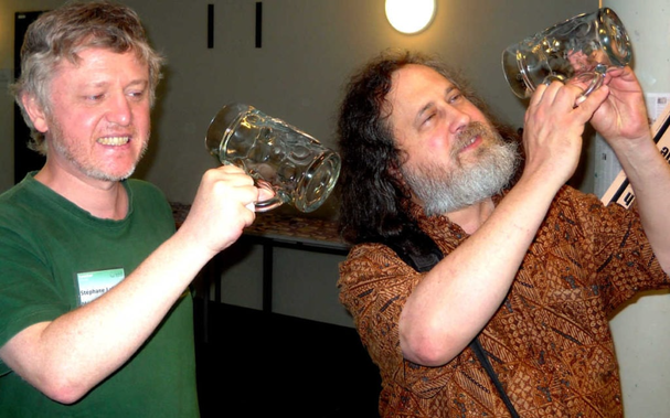 Richard Stallman and Stephane Laborde seeing empty jar of beer as a joke of the free software not as free beer phrase.