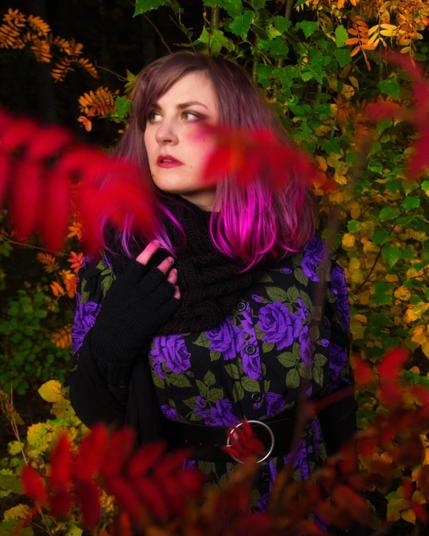 Portrait of a purple haired woman in an autumn forest