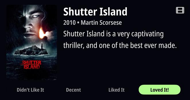 Movie poster for "Shutter Island" (2010) directed by Martin Scorsese. Dark, moody poster features a close-up of a face illuminated by a match flame against a stormy background. Below, a rocky island with a lighthouse sits in turbulent waters. Title appears in red text. Bottom of image shows a rating scale from "Didn't Like It" to "Loved It!" with "Loved It!" highlighted in bright green. Text states "Shutter Island is a very captivating thriller, and one of the best ever made."