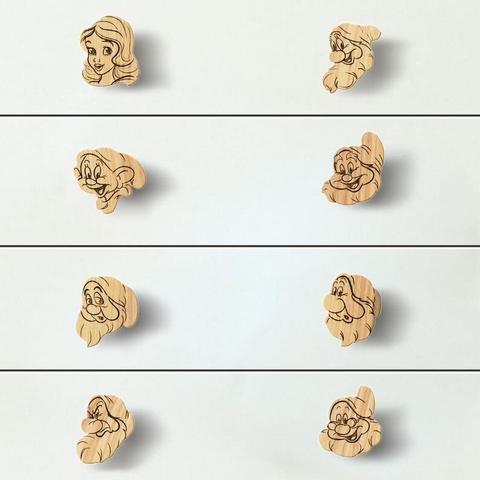 Four rows of wooden drawer knobs, each shaped and engraved with the faces of characters from the classic Disney movie "Snow White and the Seven Dwarfs." Each knob features a different dwarf, with detailed engravings that capture their distinct facial expressions and features.