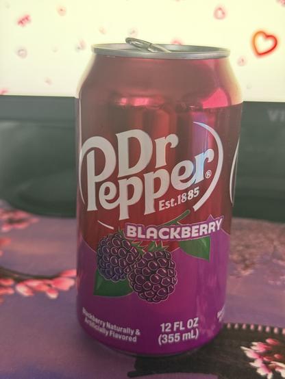 A photo of a can of Dr. Pepper Blackberry sitting on my computer desk. You can see my mouse pad underneath it and part of my monitor in the background.