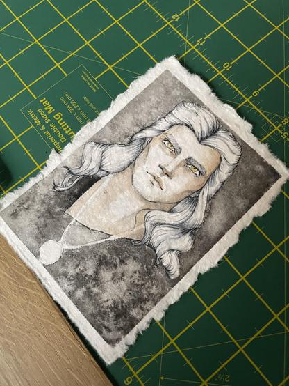 Angle picture of a drawing of Geralt of Rivia from The Witcher: front comic-style portrait with pale skin, white long hair resting of the shoulder, yellow eyes. The black shirt blends with the black background. Second layer of watercolour and outlines and details of hair and eyes marked in ink