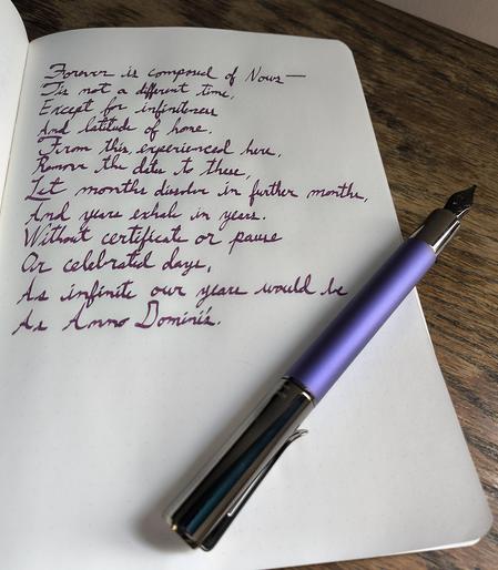 Forever is composed of Nows by Emily Dickinson, handwritten in cursive with a  purple metal bodied fountain pen laid across the page.