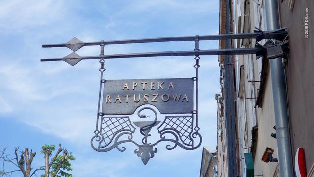 Wrought iron pharmacy sign, serpent coiled around a goblet.