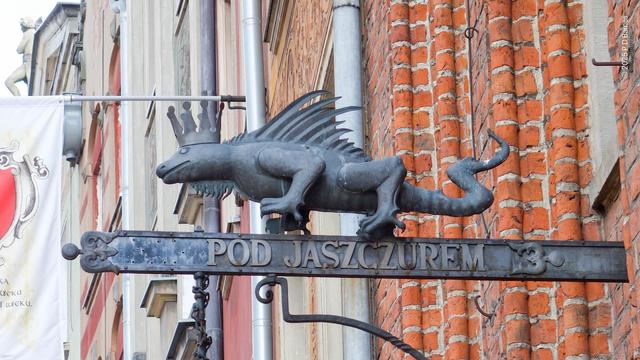 Wrought iron and beaten metal sign, three dimensional iguana wearing a crown