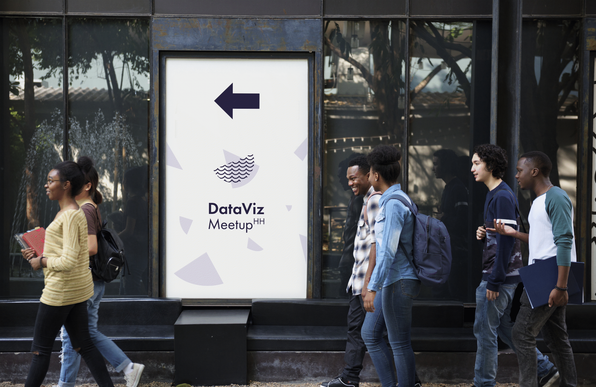 People walking by a sign with the logo of the dataviz meetup hamburg.