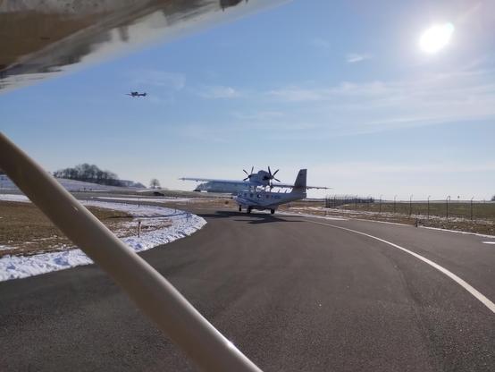 Dornier Seastar at holding point alpha runway 04. I'm number two. Another plane (Aquila) landing.