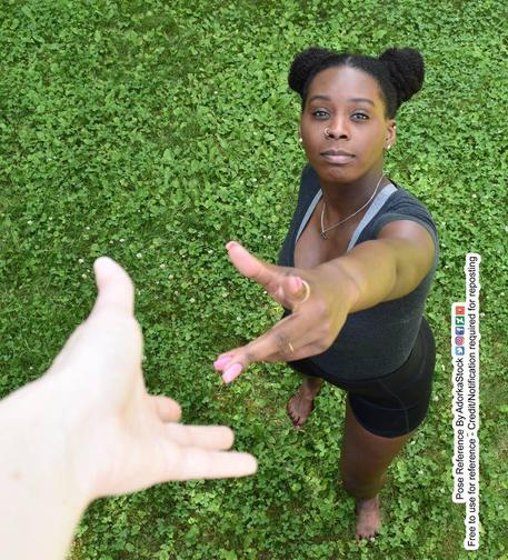 A Black woman reaching upwards towards a white woman's hand reaching down towards her.
