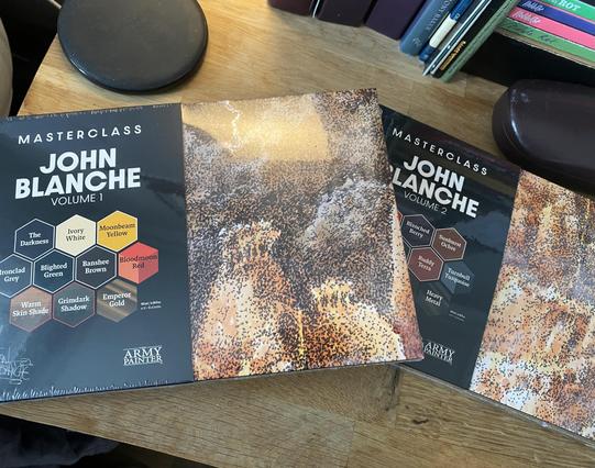 Two paint sets from The Army Painter. Both have a piece of John Blanche’s Art on the cover and are volumes of paints designed in tandem with him.