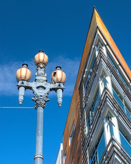 An old-fashioned lamppost juxtaposed against a modernist building
