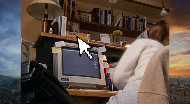 A screencap from the 1995 movie The Net. The back shoulder of Sandra Bullock in a white sweater as she sits at the computer of her home office. On the desk is a CRT monitor, possibly 15", and on the bookshelf above it is a box for the video game Civilization, released by Micropose in 1991.