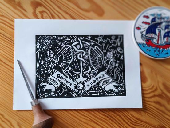 A linocut - black doves with white roses holding a ribbon with runes arranged in "carpe noctem" - around them various constellations referring to the lyrics of Sleep Token songs