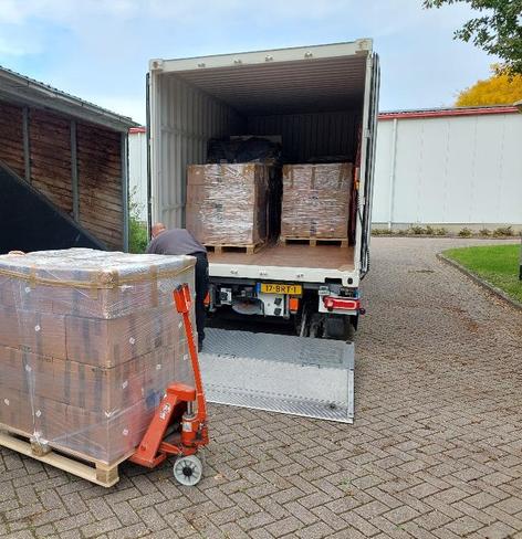 Netherlands Agronomic Historical Institute's collection being loaded for transport to be digitised and made available on Archive.org. Photo shows a truck with pallets stacked with boxes