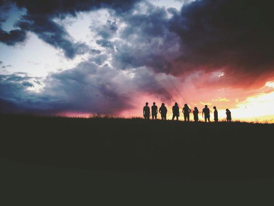 Unsplash photo of 9 silhouetted dark figures on a hill, under glorious turbulent clouds which take up most of the picture. Some clouds are darkening blues & grays while others are brilliantly lit in reds & yellows by the setting sun, going down behind the people. Mood is upbeat & wondrous, gazing out over the landscape & skyscape. 
Captioned, "silhouette of nine persons standing on the hill / SILHOUETTE SKY".

Black Forest, United States 
Dated 2017 Jan 03, by Hudson Hintze. 
www.Unsplash.com/photos/silhouette-of-nine-persons-standing-on-the-hill-vpxeE7s-my4 

www.KronoMoon.org 🏳️‍🌈 ☮️
#KronoWatch