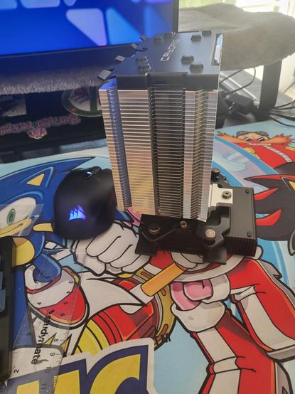 A large aluminium tower heat sink screwed to a 3d printed bracket to attach it to the aluminium back plate of a small single board computer.