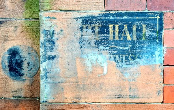 A faded ghost sign on a derelict Glasgow building which reads Court Hall Witnesses.