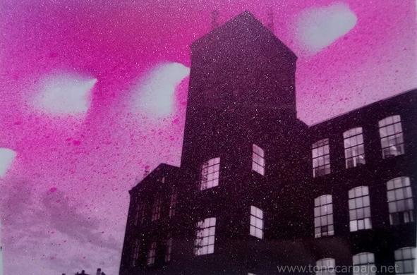 se ve un edificio de fabrica a contraluz. la fotografía está tratada con spray magenta. Hay huecos de spray en la parte superior. El aspecto general es inquietante