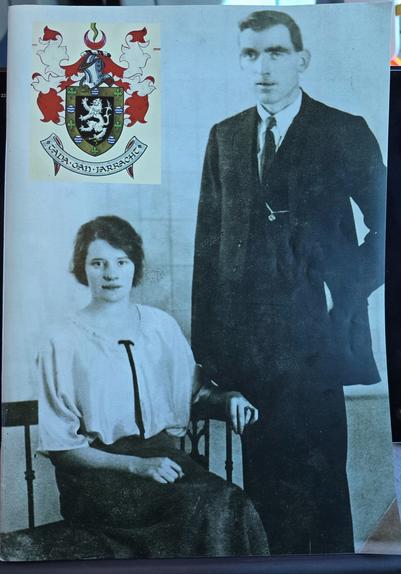 Annie Hayes and Eddie Gallagher, formal photo, probably 1920s. Gallagher coat of arms top left of image with motto in Irish Tada gan Iarracht.