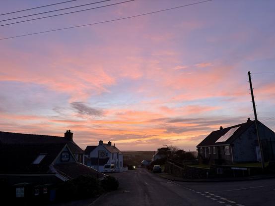 View across Trefin with the sun setting.
