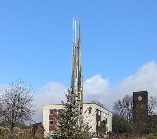 Roundabout in Merthyr Tudful with a metal something that's possibly a piece of modern art if it's not a huge metallic transmision tower.