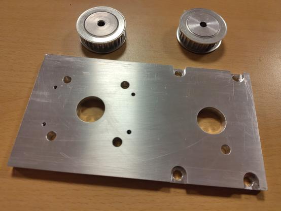 A 8mm aluminium plate and two pulleys.
There are various hole patterns in the plate that match a stepper motor.