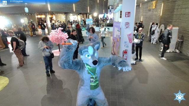 Veelkoov the wolf fursuiter is posing with a giant crayon as a knife approaching the camera