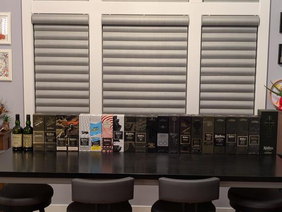 Back row of Ardbeg bottles on a table