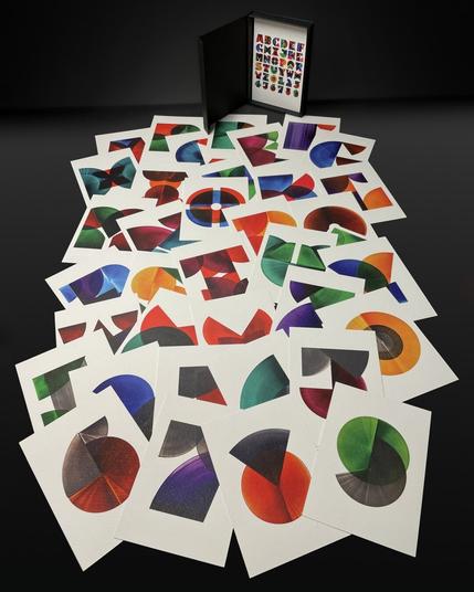 Colorful overview of all forty cards and the box, photographed against a black background.