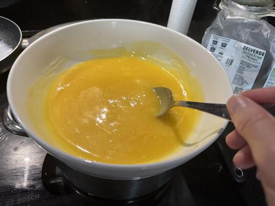 a bowl of lemon curd cooking
