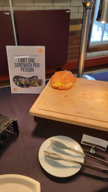 May be a a carved pumpkin on a table

Text extracted: LIMIT ONE SANDWICH PER PERSON