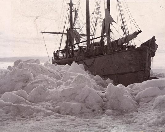 image/jpeg a three masted ship sits on a large expanse of rugged ice. The Fram.
Public Domain.