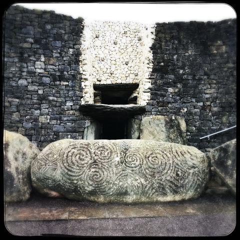 View of the stones with stone art at the entrance to Newgrange.