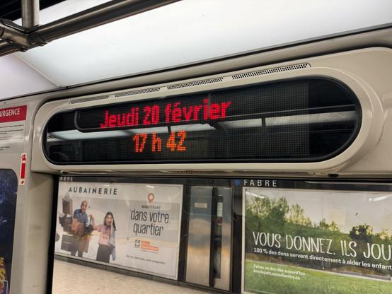 LED display (in 2025) affixed above the window inside a subway train, showing two lines of text:

Line 1, in red: Jeudi 20 février 
Line 2, in orange: 17 h 42