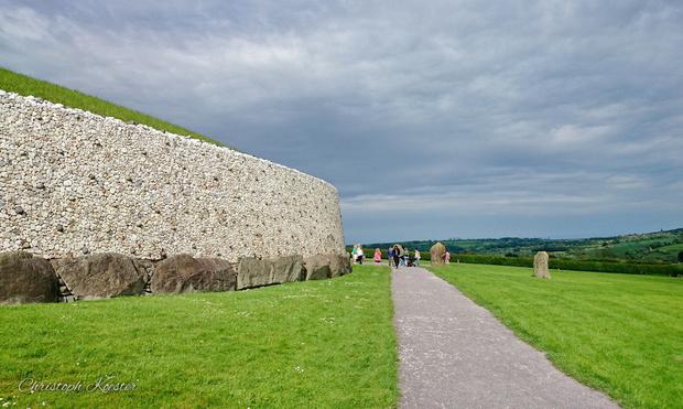 View of the prehistoric Newgrange Monument (left) towards the entrance.