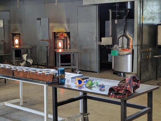 Kilns for glass blowing, with colored glass bits in foreground