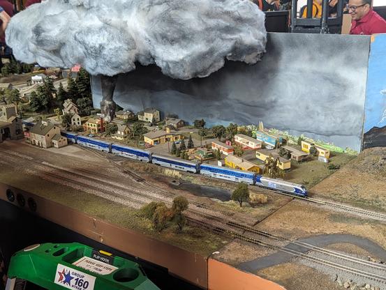 An Amtrak Surfliner moves through an N-scale tornado scene