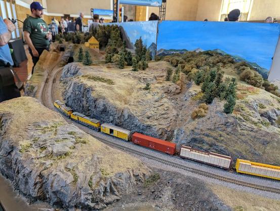 A Union Pacific mixed freight rounds the bend as it goes through a cut