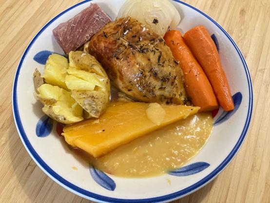 Jigg's dinner or boiled dinner with potato, cabbage, carrot, turnip (rutabaga on the mainland), salt beef, peas pudding, roast chicken, and gravy.