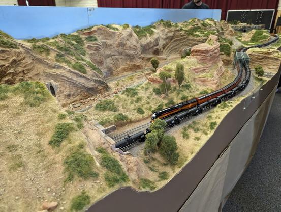 A Southern Pacific Daylight passing by a tank train