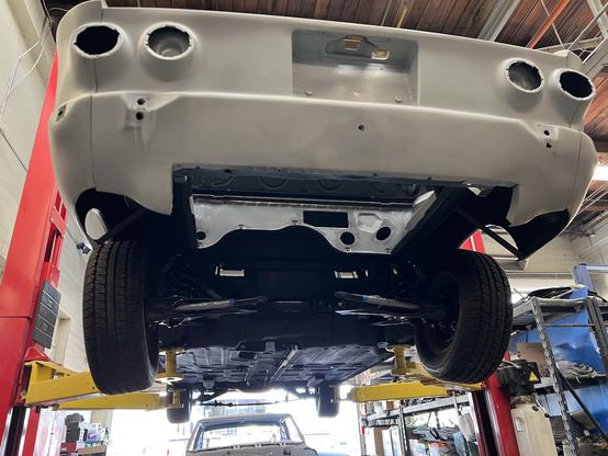 Rear of 1964 Corvair on lift.