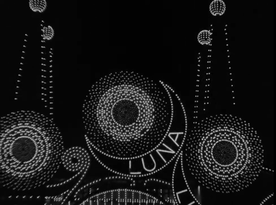 A black and white still from the film Speedy that shows the lights at Coney Island spelling out the word LUNA