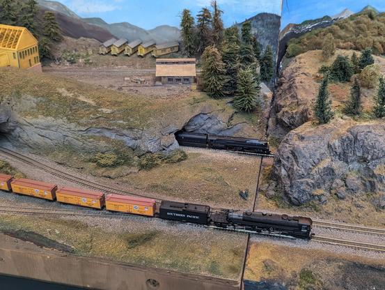 2 steam locomotives parallel each other on the main line
